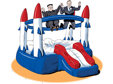 Kim and Moon bouncing on a inflatable trampoline that looks like rockets